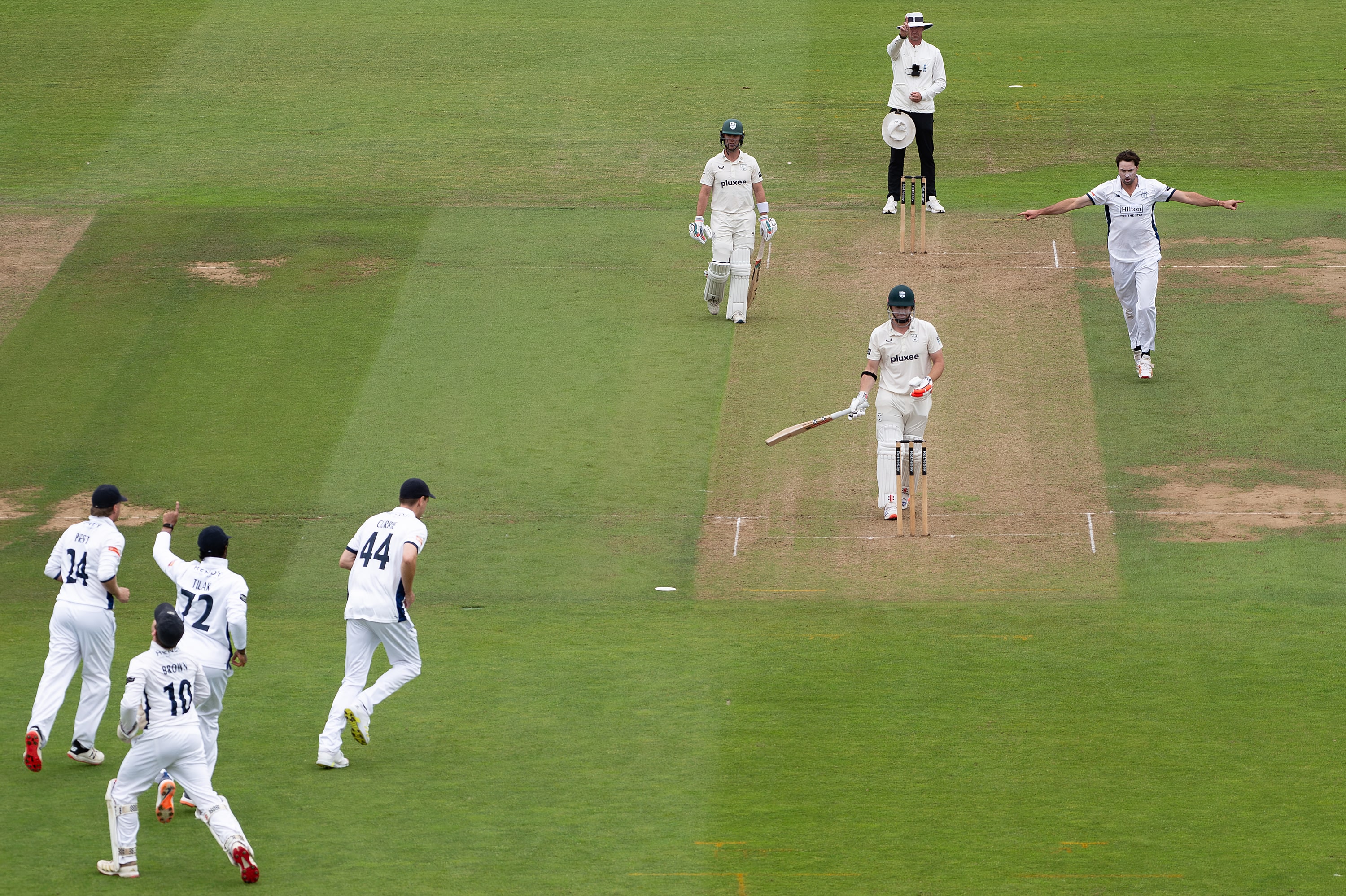 James Fuller celebrates taking the wicket of Worcestershire's Henry Nicholls as the keeper and slips run up to join him