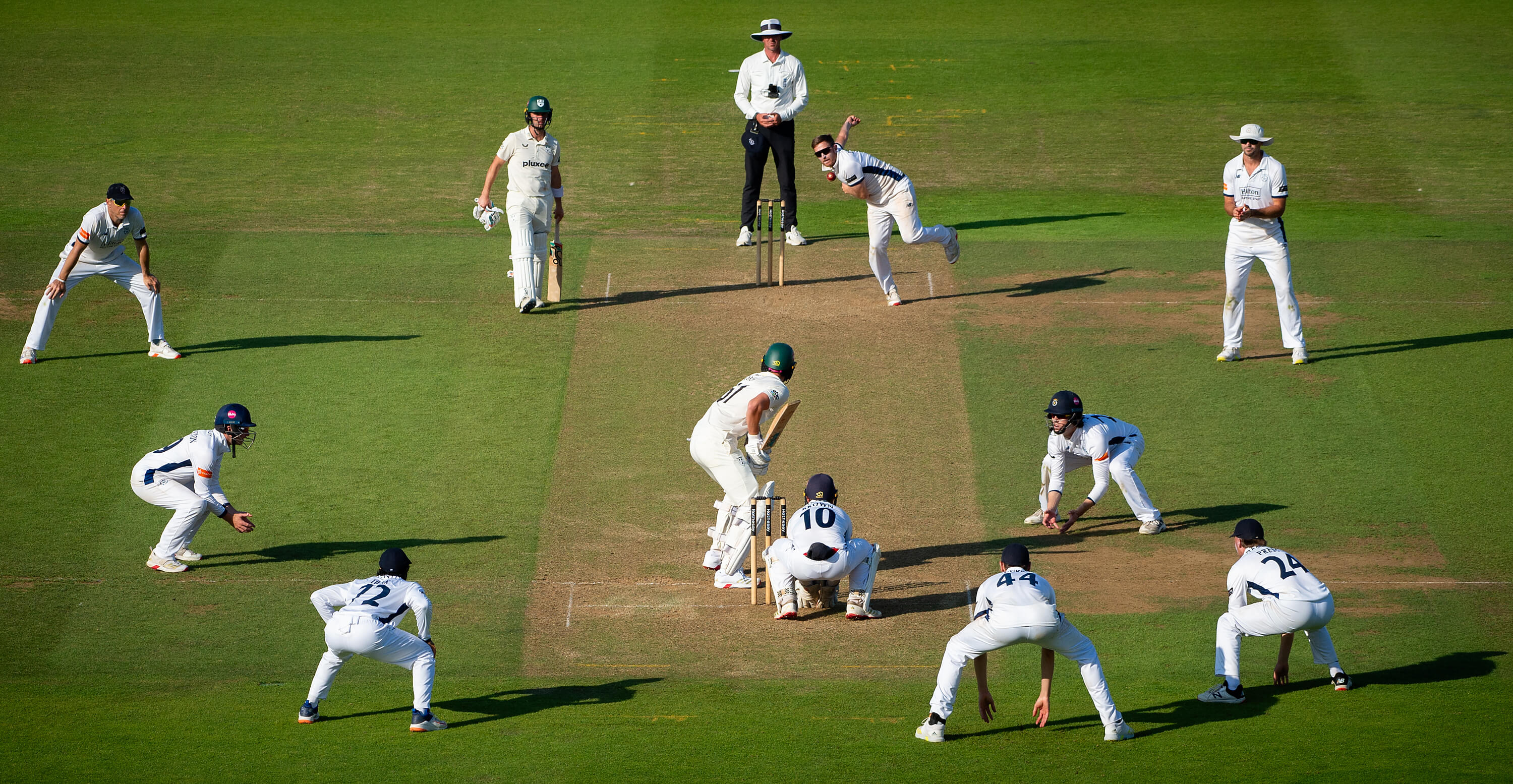 Fielders surround the bat as Liam Dawson bowls to Worcestershire's Adam Finch at Utilita Bowl